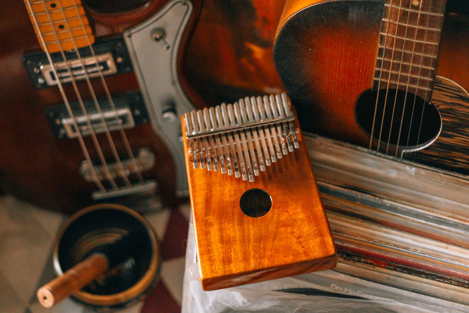 A variety of musical instruments including a kalimba and guitars arranged creatively.